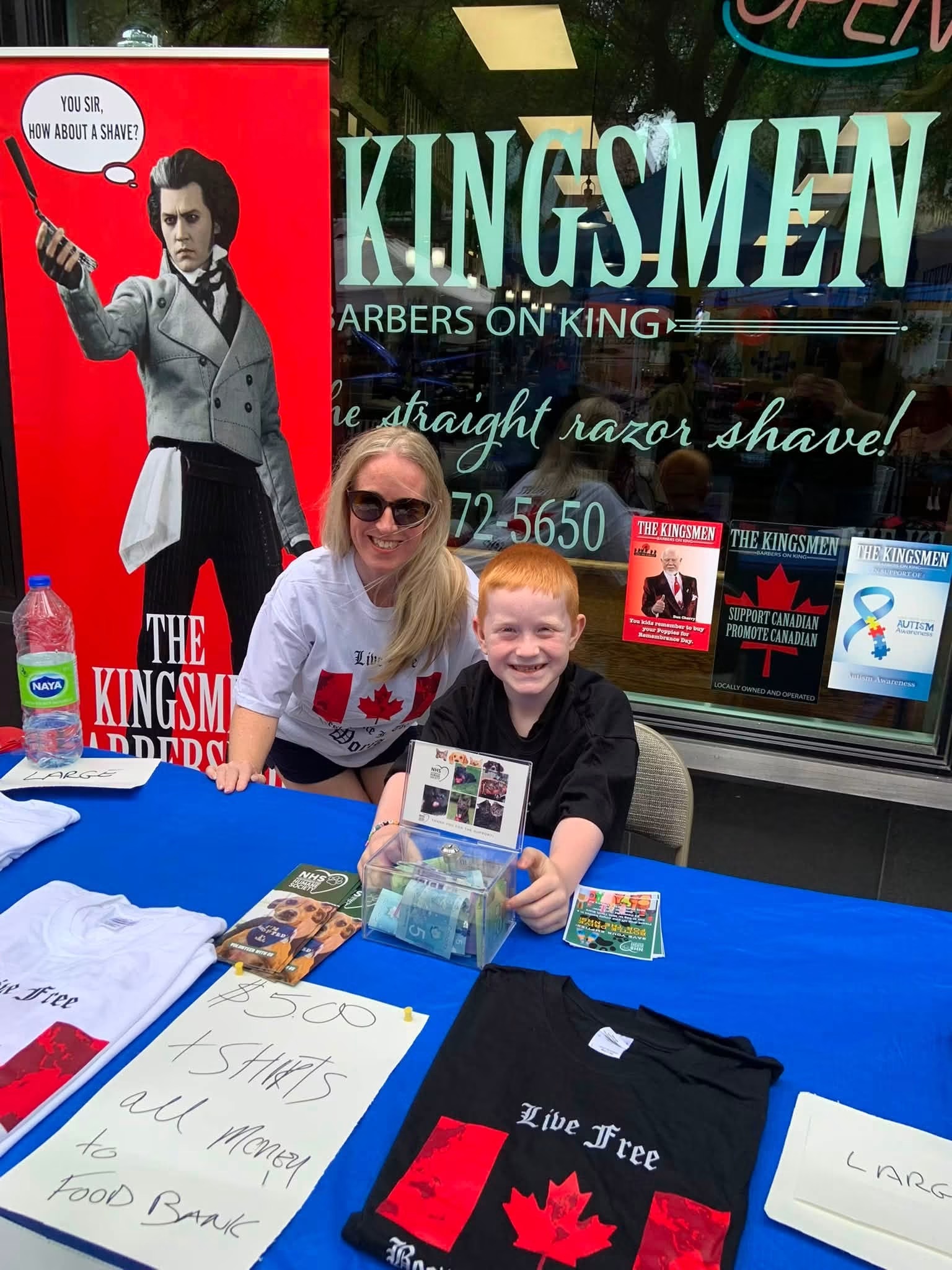 Lindsay Grimley and her son at a community fundraiser table in Cobourg